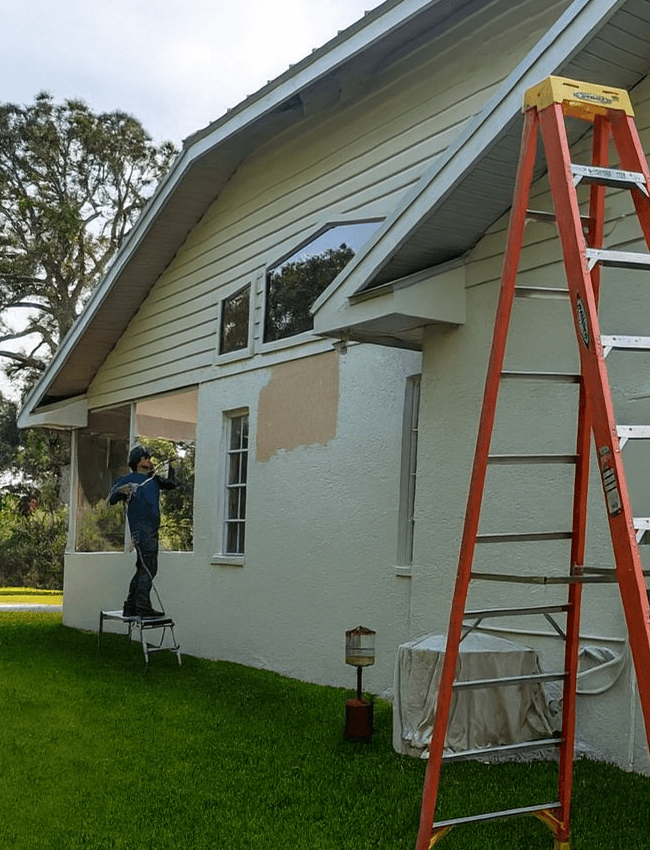 Rolling paint in a pressure roller on a house